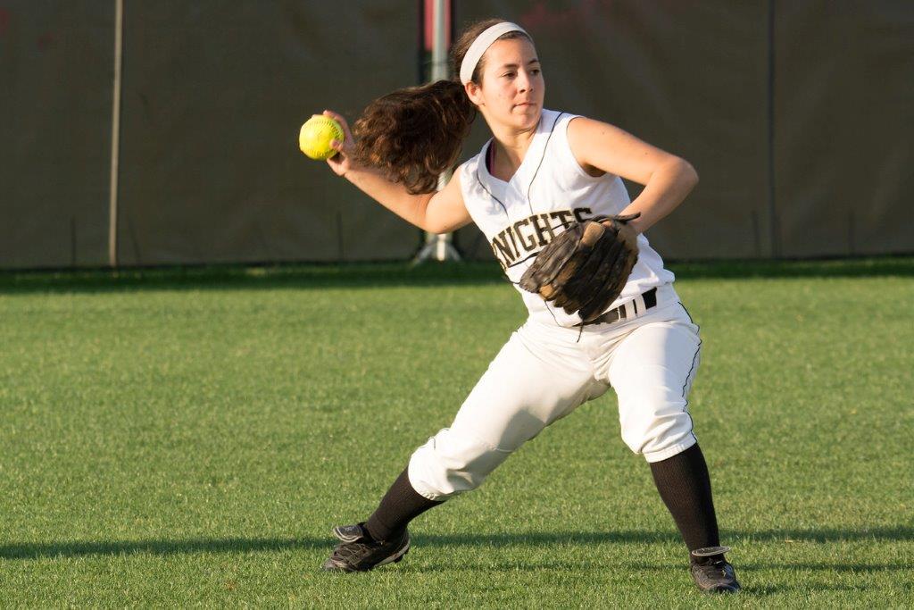 Softball player throwing ball