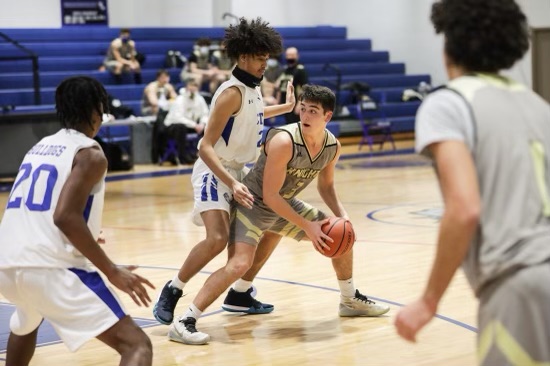Boys basketball passing ball at a game