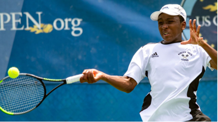 Boys tennis player hitting ball
