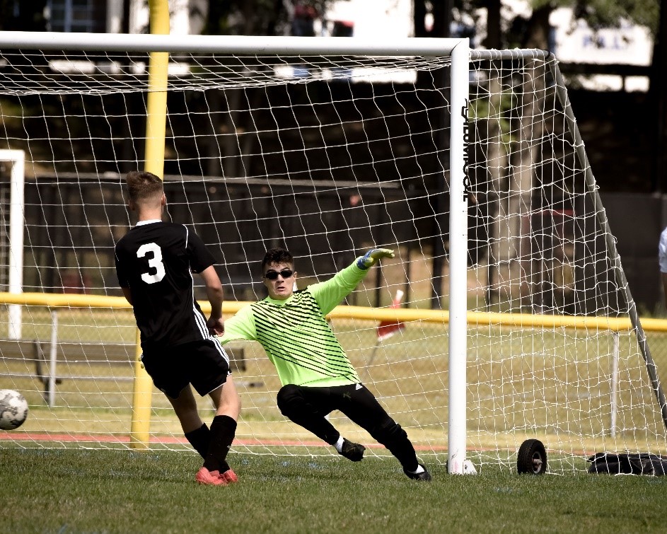 Boys soccer goalie at game